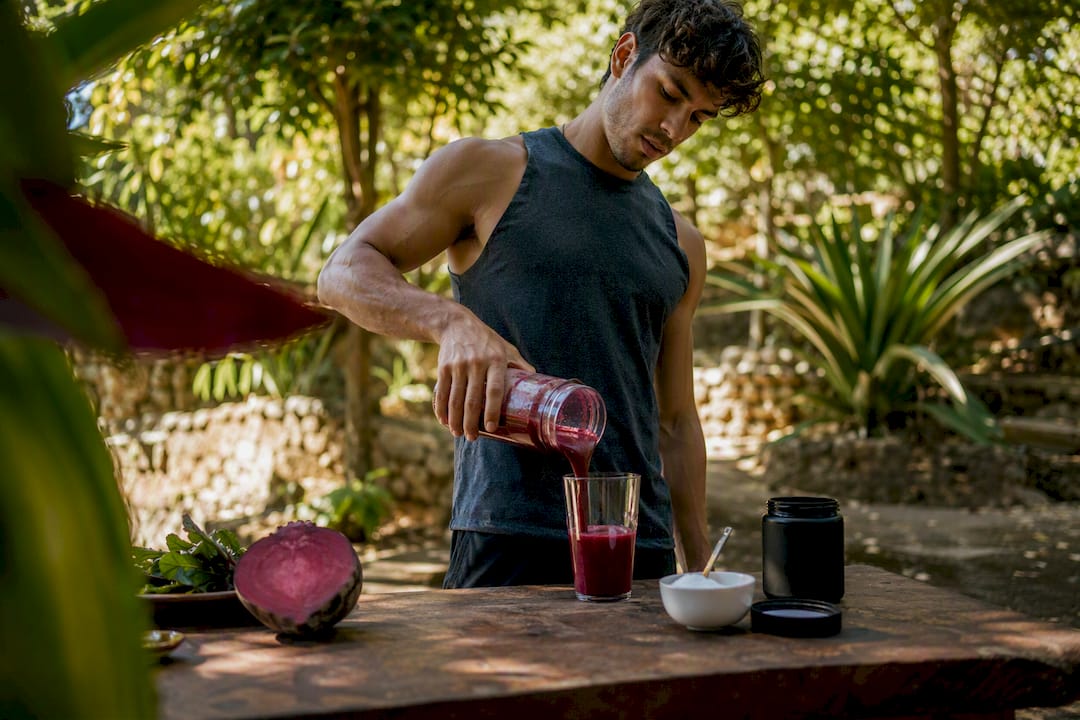 Athlete pouring beetroot juice for ergogenic aid