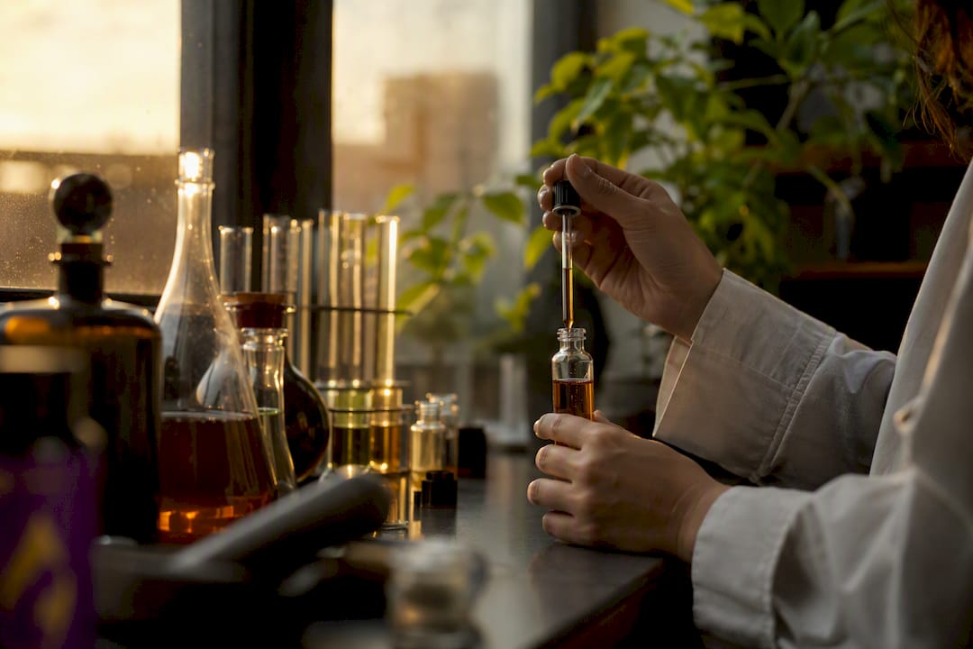Hands mixing herbal nootropic extract in lab