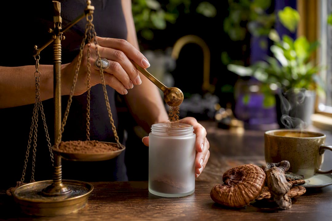 Hands measuring reishi powder supplement