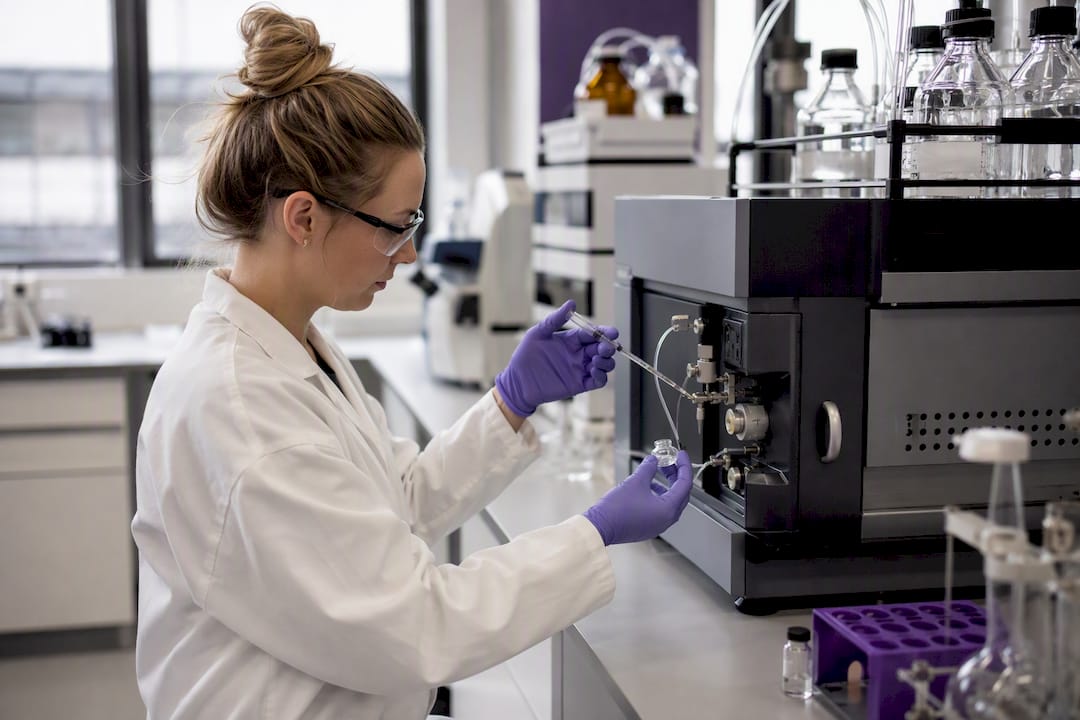 Technician pipetting peptide sample in lab