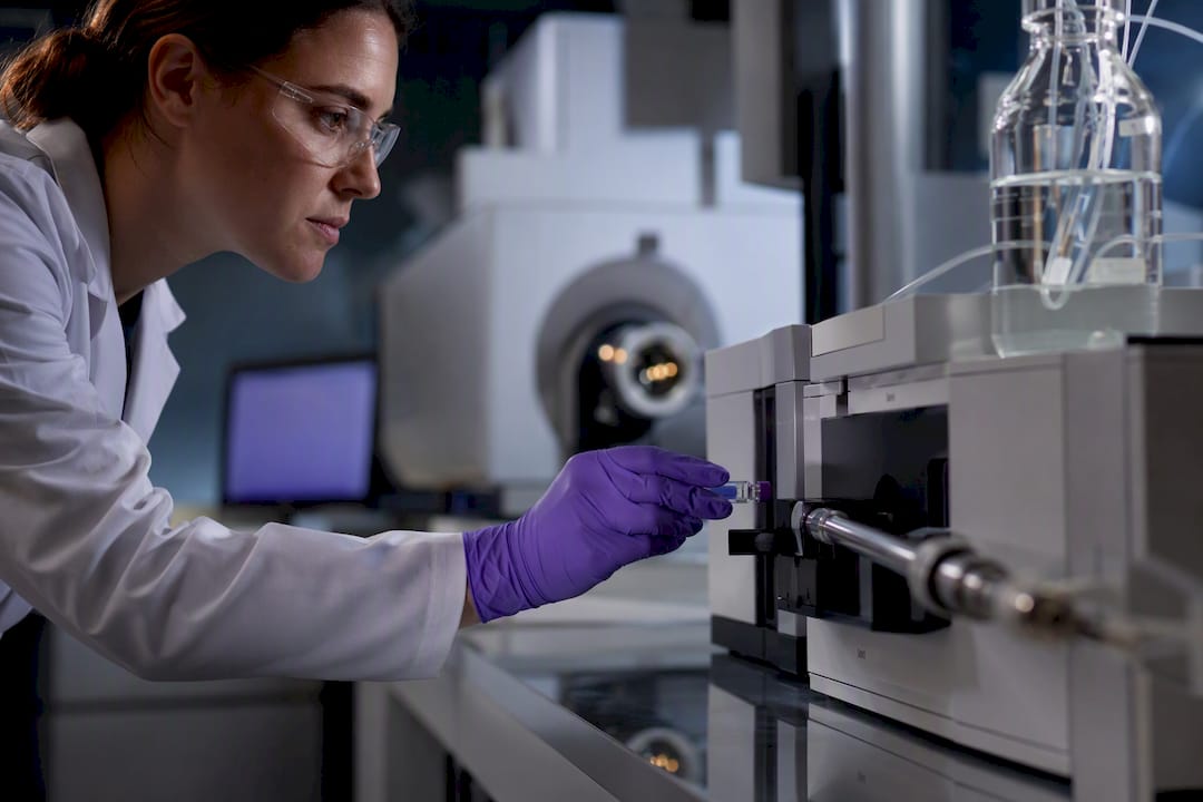 Chemist preparing liquid chromatography analysis