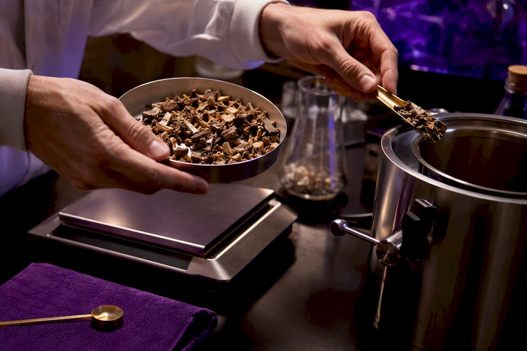 Measured mushroom material beside extraction vessel