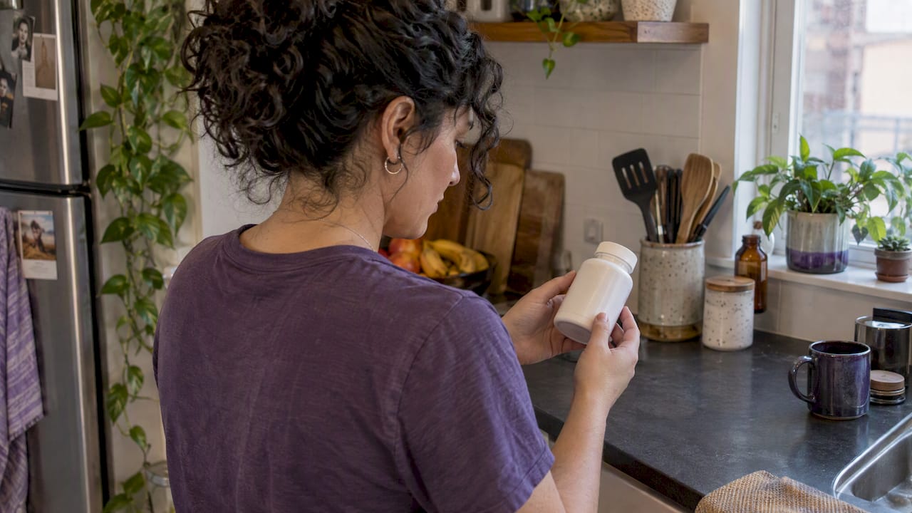 Shopper checking a supplement bottle label